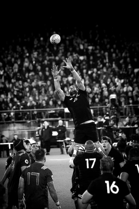 grayscale photo of NFL player catching ball