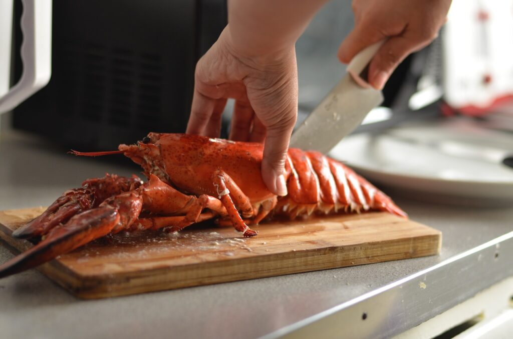 person cutting lobster