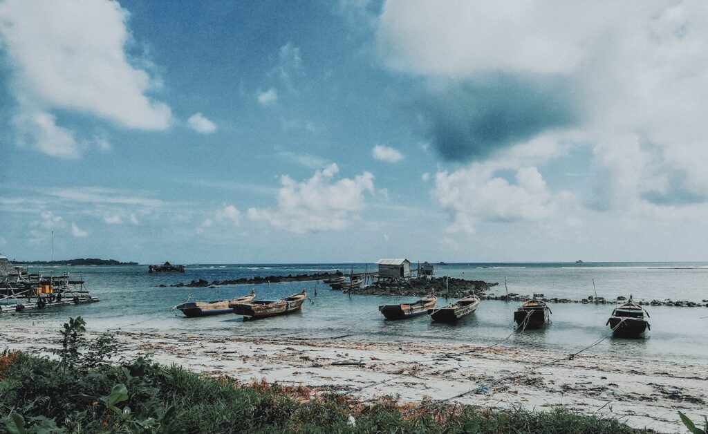 grey wooden boats on body of water during daytime