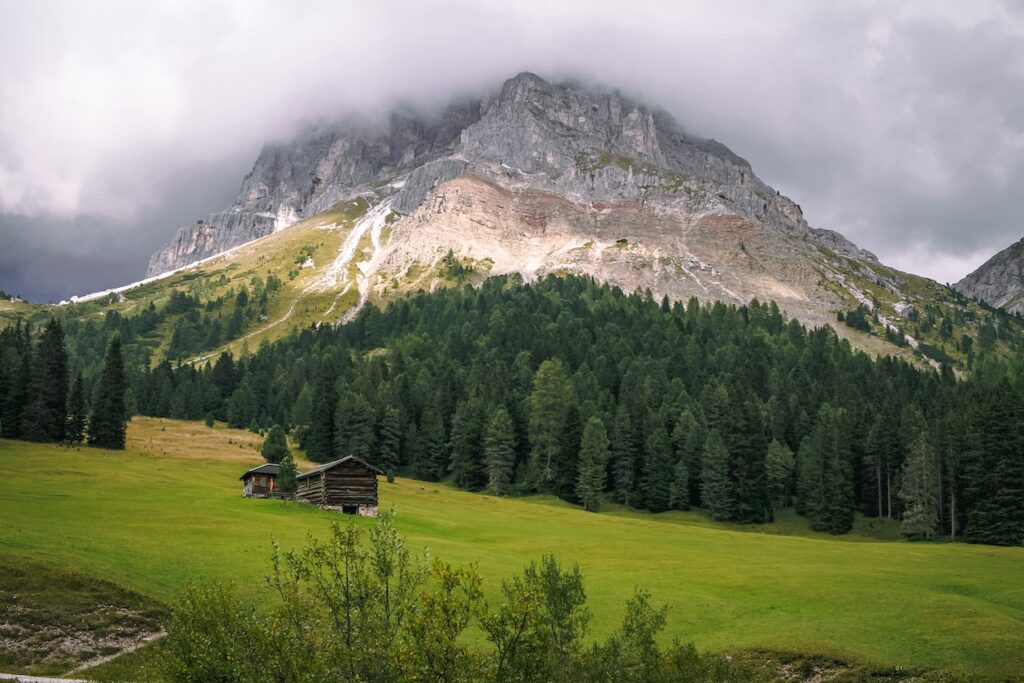 green grass field near mountain during daytime
